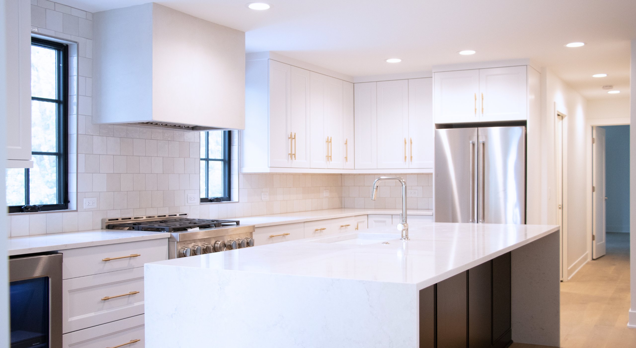 Black and white kitchen in a full home remodel in Regency, Omaha, designed to highlight bold heirlooms and collected artwork.