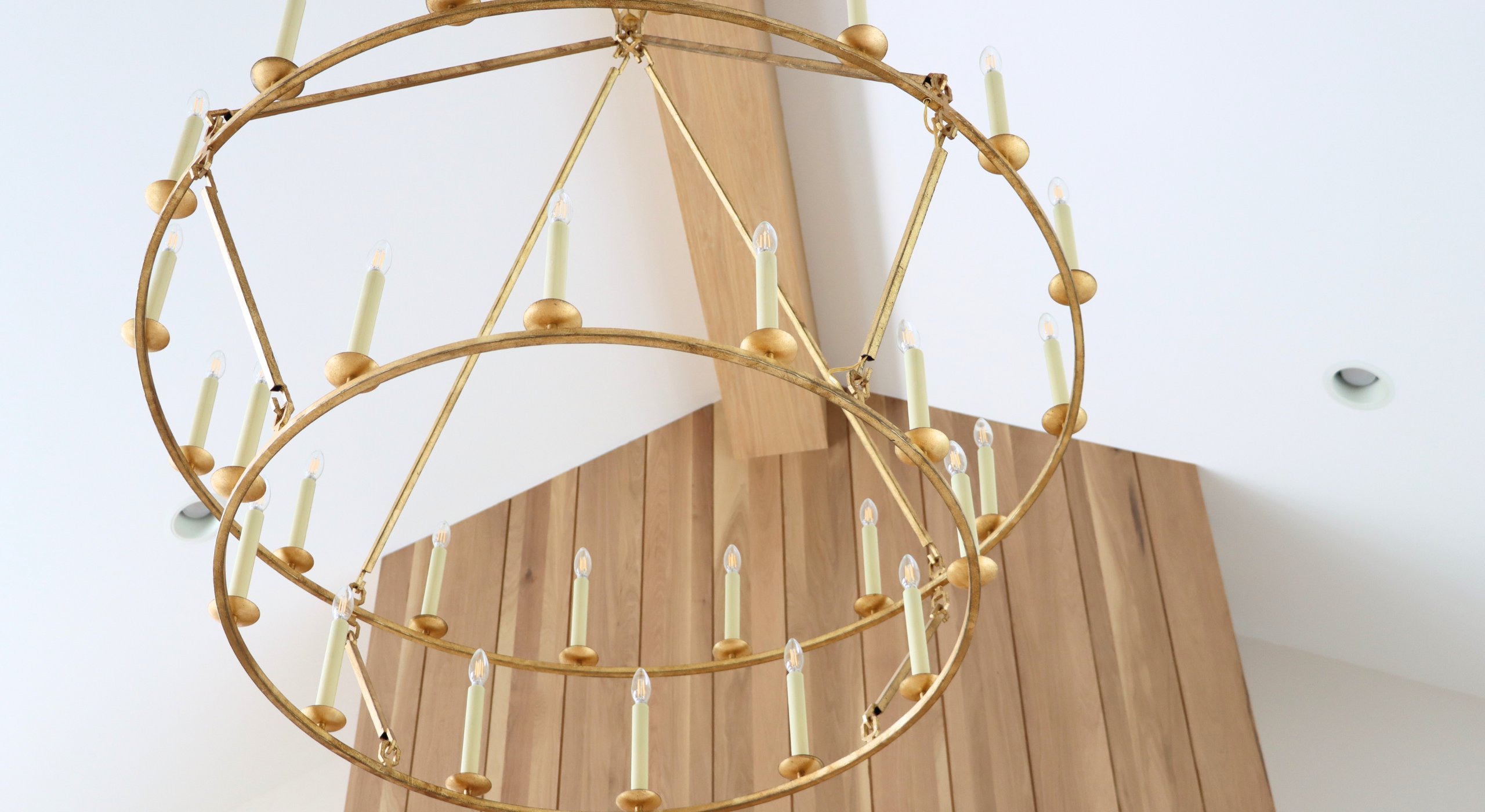 Oversized chandelier and floor-to-ceiling fireplace in new construction home in Elkhorn, Nebraska.
