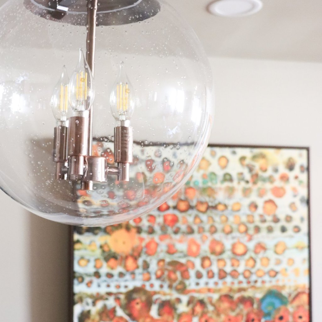 Blown glass pendant lighting above breakfast bar with custom painting in Lincoln condo.