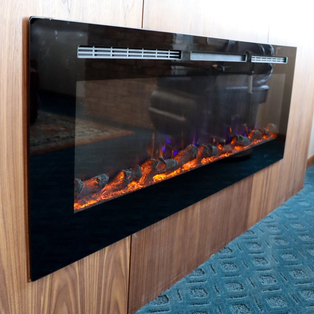 Custom paneled electric fireplace in Lincoln condo living area.