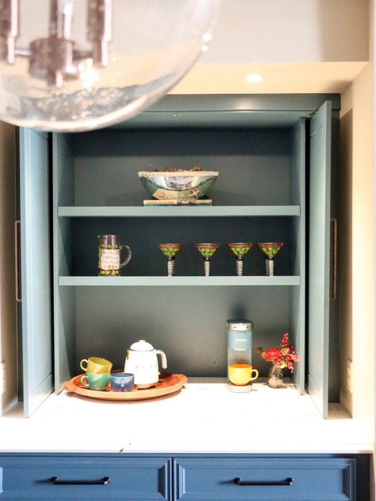 Open view of custom breakfast nook with blue cabinetry and built-in coffee bar in Lincoln condo.