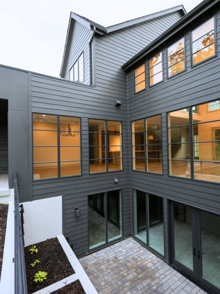 Exterior of three-level custom home in Elkhorn featuring an atrium-style lower level and contemporary architecture.