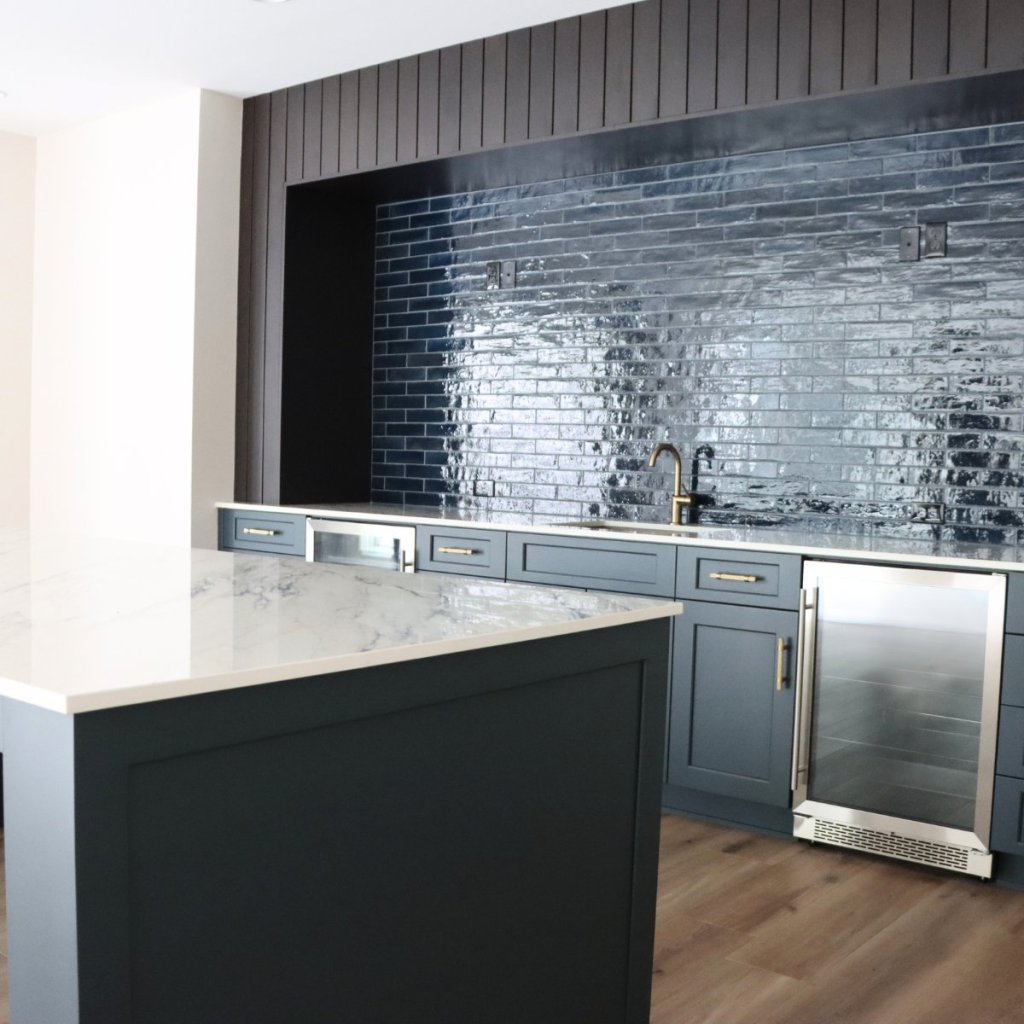 Deep blue lower level kitchen featuring a wine cellar in custom home.