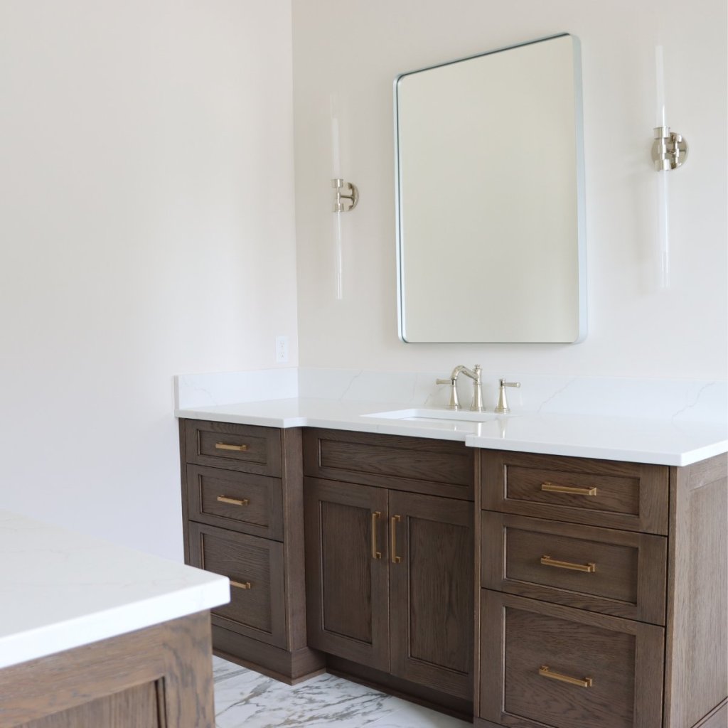 Primary suite bathroom vanity with designer finishes in custom Elkhorn home.