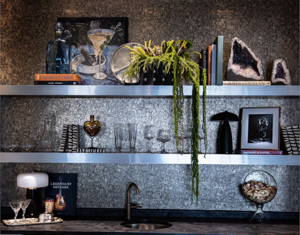 Uniquely styled bar shelves and curated bottle display in a downtown Omaha condo.