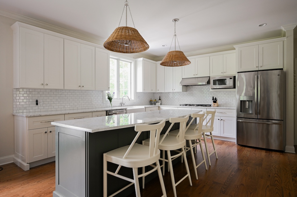 White kitchen remodel with natural woven accent lighting